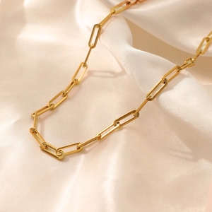 Minimalist gold plated titanium steel paperclip chain necklace on soft silk fabric