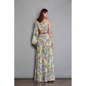 Detail of floral maxi dress showing one-shoulder sleeve and waist cutout with gold chain