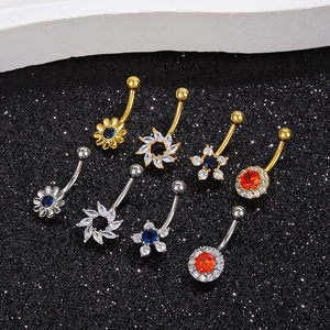 Set of 8 gold and silver belly rings with colorful zircon inlays on black background
