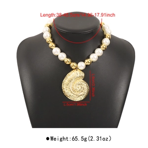 Detailed view of oversized gold conch pendant with mixed large white imitation pearls