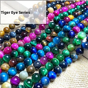 Close-up of multicolored tiger eye stone round beads with chatoyancy effect on burlap