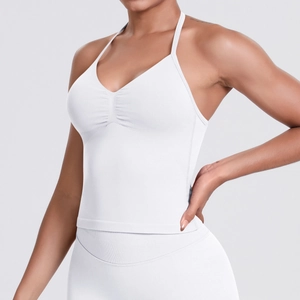 Detailed side view of white seamless racerback sports top with ruching and high waist leggings
