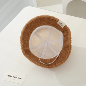 Detail of caramel teddy fleece baby bucket hat showing interior lining and elastic cord