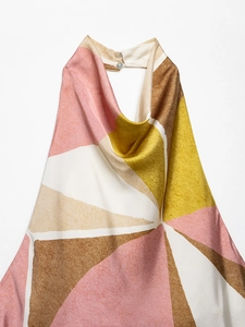 Detail of colorful geometric print halter top with button neck and silky texture