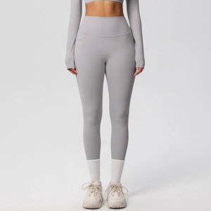Detailed view of high-waist grey yoga pants with wide waistband and functional side pockets