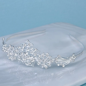 Close-up of floral silver alloy headband featuring sparkling rhinestones and leaf motifs