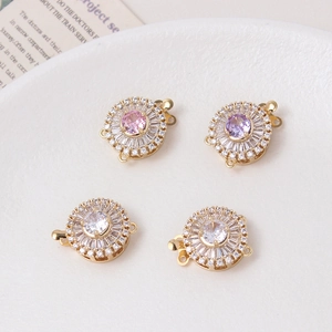 Macro view of flower-shaped 14K gold plated pave zircon and pearl clasps for jewelry making