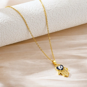 Gold Hamsa Hand necklace with heart-shaped Evil Eye pendant and sparkling accents