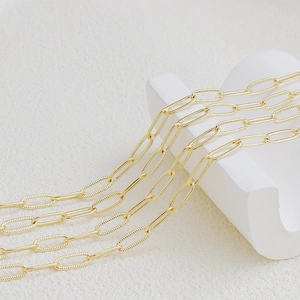 18K gold plated paperclip chain necklace on white geometric prop minimalist jewelry