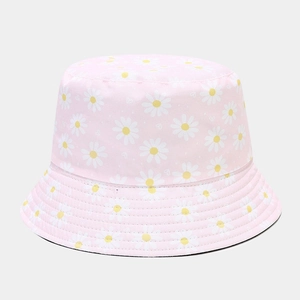 Detailed view of pink floral bucket hat with white daisy embroidery and reinforced stitching