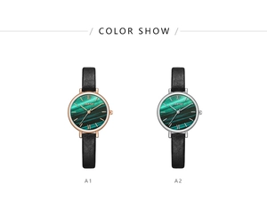 Detail view of quartz watches with green malachite dials in rose gold and silver cases