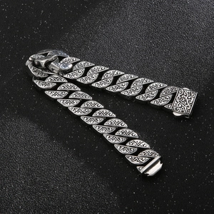 Detailed view of vintage silver titanium steel Cuban bracelet with floral pattern engraving