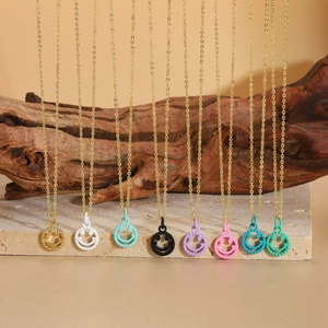 Artistic close-up of colorful smiley face pendants on gold chains with luxury stone props