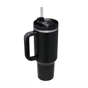 Close-up of the matte black 40oz stainless steel travel mug with handle and clear straw