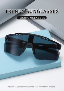 Detail view of black oversized cycling sunglasses on a blue geometric prop background