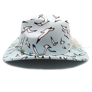 Detail of light blue wide brim felt hat with white seagull prints and beaded rope band