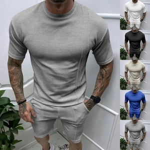 Detail of grey men's summer set showing waffle knit texture on t-shirt and shorts