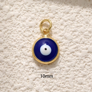 Macro detail of a 10mm round gold-plated evil eye pendant with blue and white enamel inlay