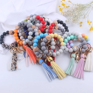 Detail of colorful silicone bead wristlet keychains with leather tassels and gold rings