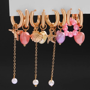 Gold hoop earring set with hummingbird starfish charms and ceramic heart dangles
