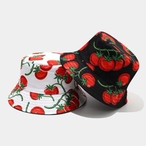 Detailed close-up of tomato patterns on reversible cotton sun hats in black and white