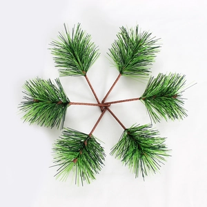 Detailed view of six lifelike green artificial pine needles for Christmas decoration