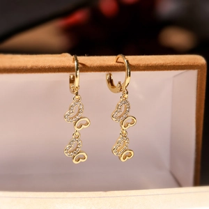 Elegant gold-plated triple butterfly drop earrings with cubic zirconia on jewelry box