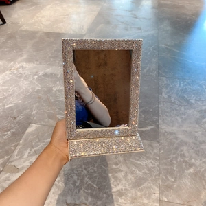 Macro detail of foldable vanity mirror with luxury sparkling rhinestone inlaid frame