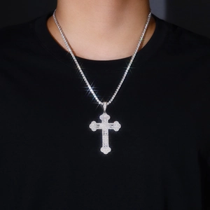 Macro shot of silver S925 cross pendant with hip hop moissanite and star flare effect