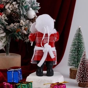 Detail view of the plush Santa doll back showing the red plaid coat and festive ornaments