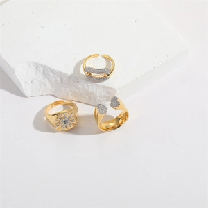 Three-piece gold adjustable ring set featuring hollow heart and sun coin designs