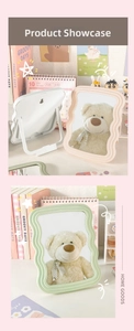 Detail of wavy frame vanity mirrors in pink and green with foldable desktop stands