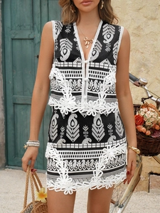 Detail of bohemian black and white patterned two-piece set with delicate lace trim