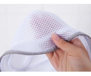 Close-up of durable fine mesh laundry bag with gray zipper for delicate bra protection