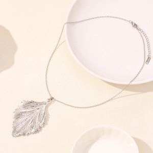 Detail of leaf pendant necklace showing fine leaf veins and stainless steel texture