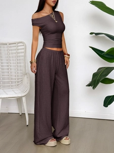 Detail of dark brown textured fabric on women's two-piece short sleeve and wide-leg pant set