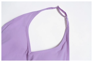 Detail of light purple yoga vest showing deep V-neckline and adjustable strap with ring