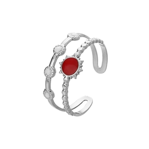 Detail of silver adjustable ring featuring red sunburst and white enamel circle elements