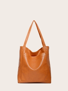 Vue détaillée du cabas vintage en cuir huilé marron avec poche frontale et anses doubles