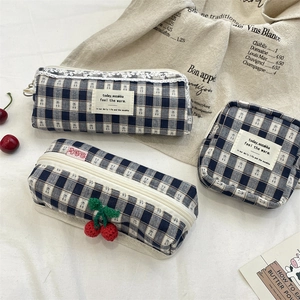 Detail of blue plaid canvas pouch set with cherry crochet and lace trimmings