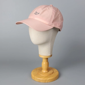 Pink quick-dry baseball cap with elephant embroidery on a mannequin head model