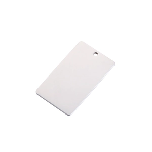Macro detail of polished stainless steel rectangular pet tag with a pre-drilled hole