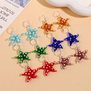 Detail of colorful 3D glass starfish pendants with white polka dots for jewelry making