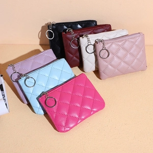 Detailed close-up of quilted multi-color mini zip wallets with silver keyrings