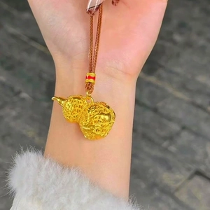Detail of 24k gold-plated hollow gourd pendant with intricate woven pattern and brown cord