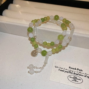 Detail of beaded bracelet with lily of the valley crystal beads and Fu character charm