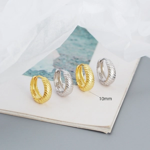 Detail of 10mm S925 sterling silver hoop earrings with irregular textured finish