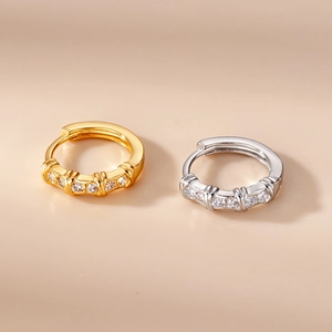 Detailed comparison of gold and silver hoop earrings featuring white zircon inlay rows