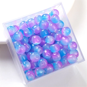 Macro shot of purple gradient barrel glass beads for DIY jewelry in a plastic box