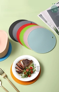 Macro view of silicone trivet mats featuring non-slip honeycomb texture in multiple colors